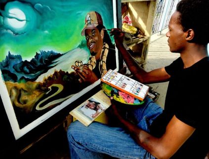 Henry Ndeges working on a painting